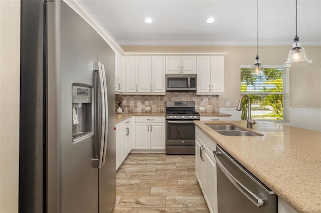 11634 Piedmont Park Xing, Bradenton, FL 34211 - kitchen with stainless steel appliances, a sink, tasteful backsplash, white cabinets, and pendant lighting