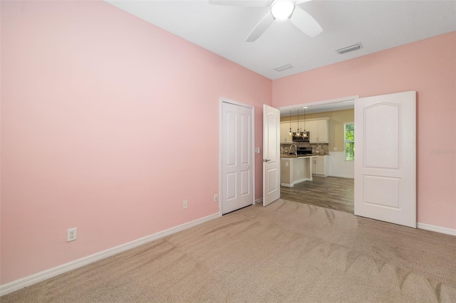 11634 Piedmont Park Xing, Bradenton, FL 34211 - spare room featuring light colored carpet, baseboards, and ceiling fan