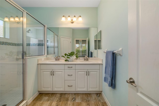 11634 Piedmont Park Xing, Bradenton, FL 34211 - full bathroom with a shower stall, double vanity, wood finished floors, and baseboards