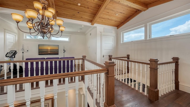 stairs featuring wood-type flooring, a chandelier, wooden ceiling, and baseboards