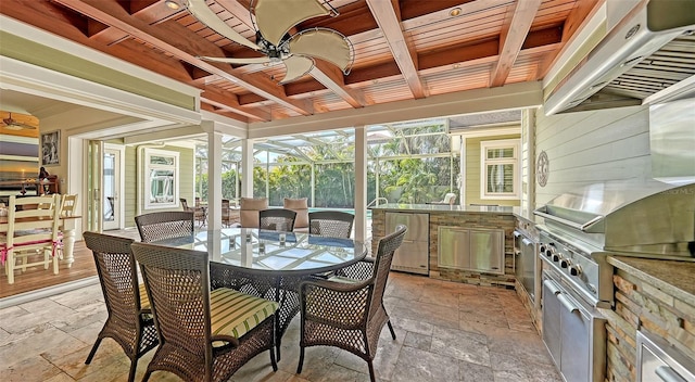 sunroom / solarium featuring ceiling fan, exterior kitchen, coffered ceiling, beamed ceiling, and outdoor dining space
