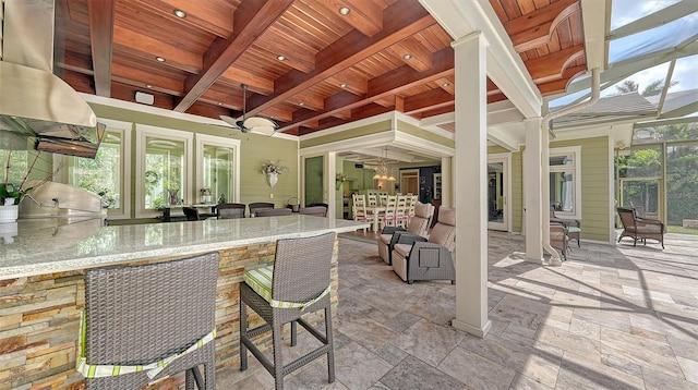 view of patio / terrace featuring exterior kitchen and ceiling fan