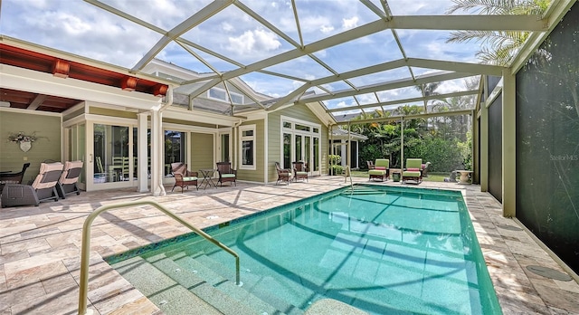 swimming pool with a patio area and glass enclosure