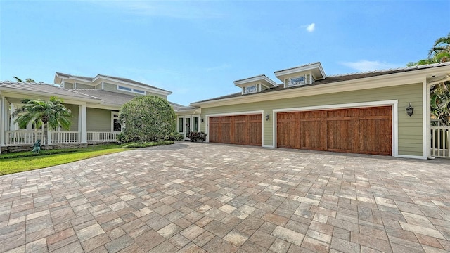 view of front of property featuring decorative driveway and an attached garage