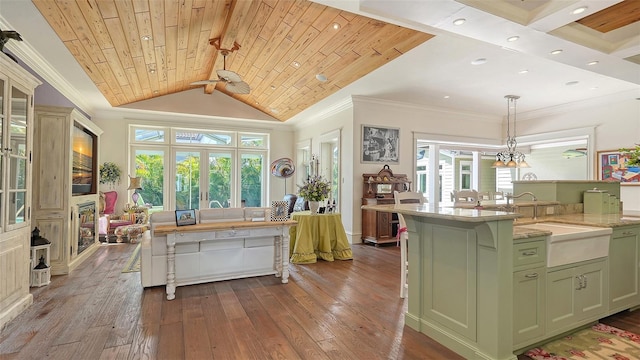 kitchen with dark wood finished floors, green cabinetry, a sink, healthy amount of natural light, and wood ceiling