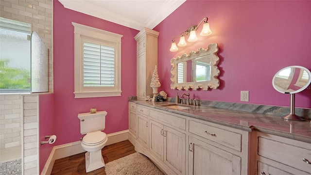 full bath with crown molding, wood finished floors, vanity, toilet, and baseboards
