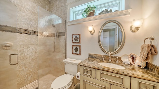 full bath featuring a stall shower, toilet, and vanity