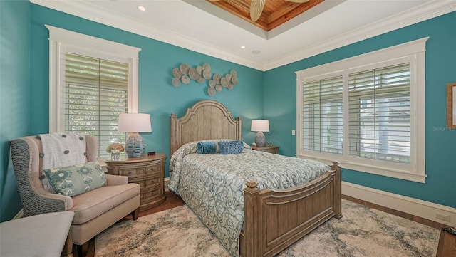 bedroom with crown molding, wood finished floors, baseboards, a tray ceiling, and recessed lighting