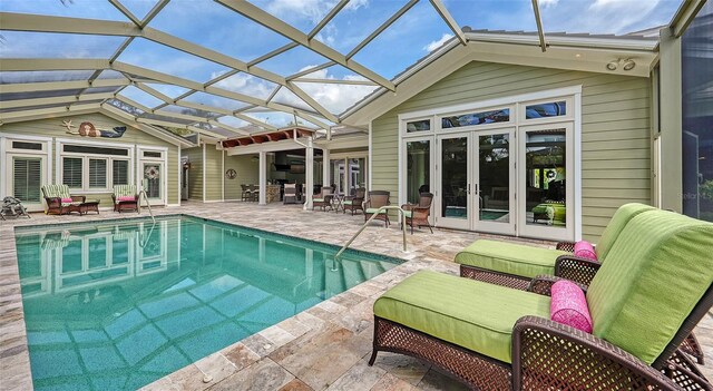 swimming pool featuring french doors, a patio area, an outdoor hangout area, and glass enclosure