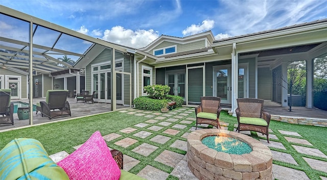back of property with an outdoor fire pit, a patio, and french doors