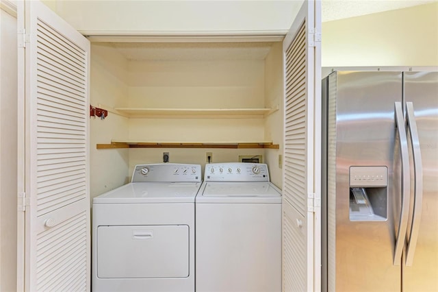 clothes washing area featuring laundry area and washing machine and dryer