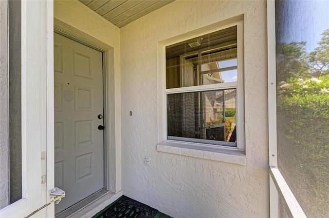 doorway to property with stucco siding