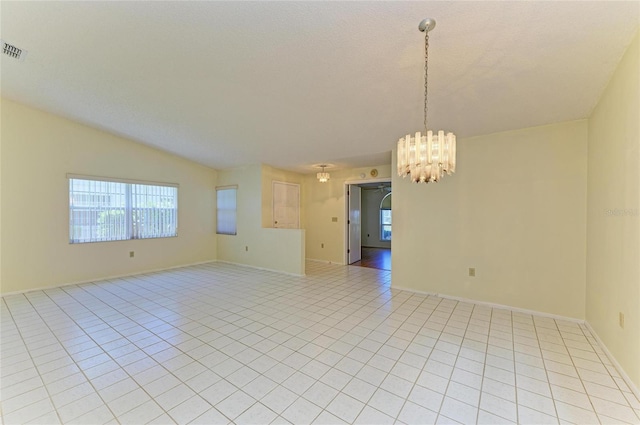 unfurnished room with visible vents, baseboards, light tile patterned floors, and a notable chandelier