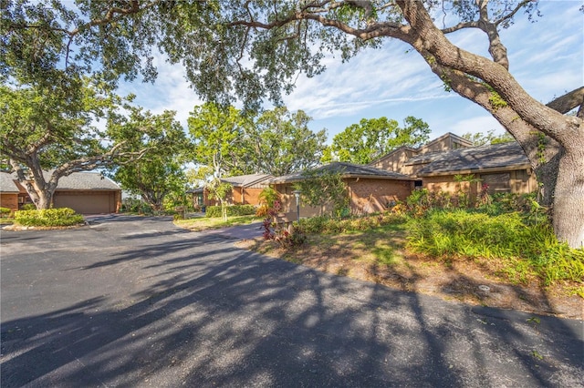 single story home featuring a detached garage