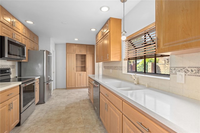 kitchen with recessed lighting, appliances with stainless steel finishes, decorative backsplash, and a sink