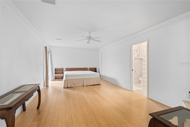 bedroom featuring a ceiling fan, ensuite bath, visible vents, crown molding, and wood finished floors