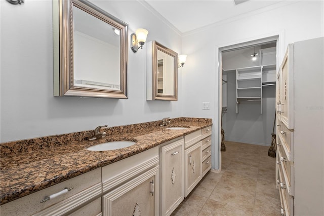 full bath with double vanity, crown molding, tile patterned floors, and a sink