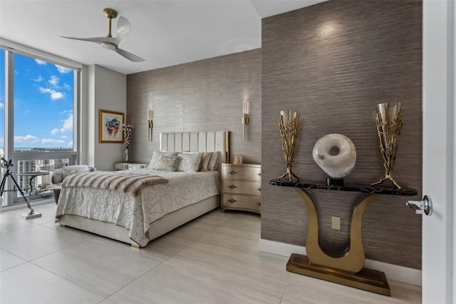 bedroom featuring floor to ceiling windows, light tile patterned floors, ceiling fan, and baseboards