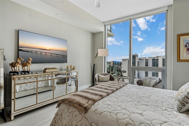 bedroom featuring multiple windows and floor to ceiling windows
