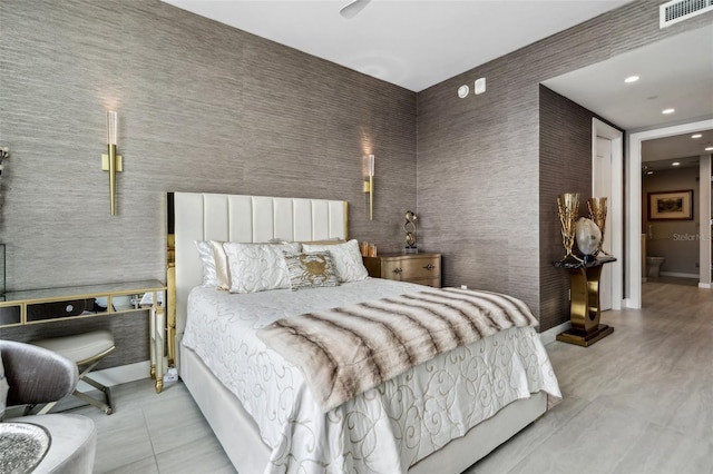 tiled bedroom with recessed lighting and connected bathroom