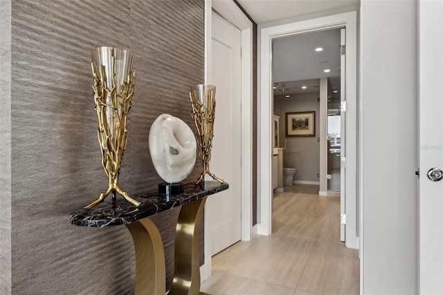 hallway featuring baseboards and recessed lighting