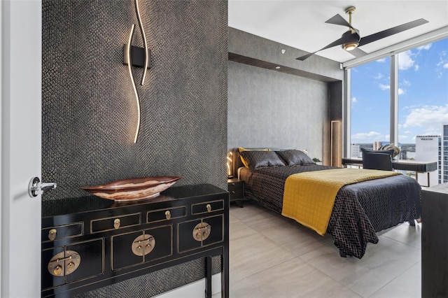 bedroom with expansive windows and ceiling fan