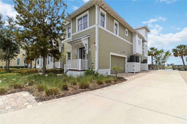 view of side of home with an attached garage, board and batten siding, and concrete driveway