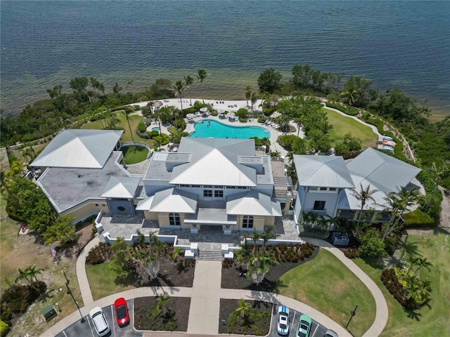 bird's eye view of a pool area and a nearby body of water