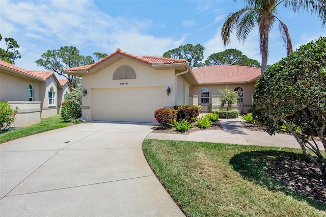 mediterranean / spanish home with a garage, stucco siding, concrete driveway, and a tile roof