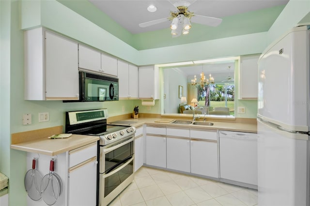 kitchen with a sink, white cabinetry, white appliances, and light countertops