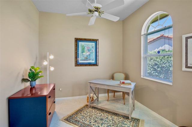 tiled office with ceiling fan and baseboards