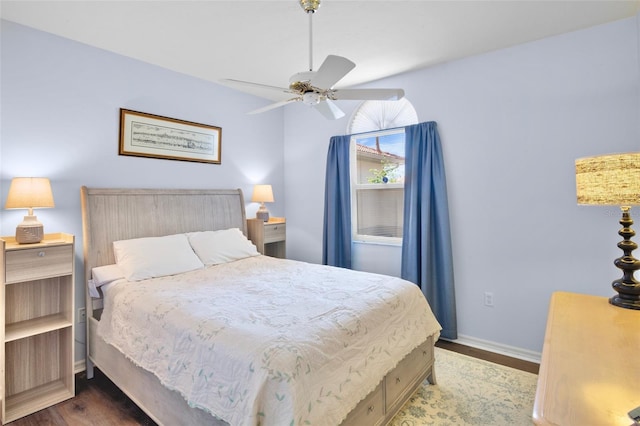 bedroom featuring baseboards, ceiling fan, and wood finished floors