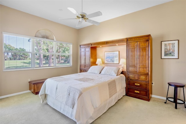 bedroom with baseboards, ceiling fan, and light colored carpet
