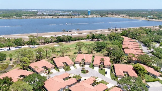 drone / aerial view featuring a residential view and a water view