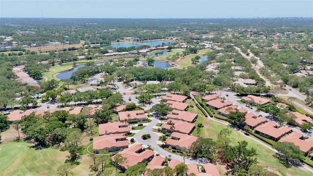 bird's eye view with a water view, view of golf course, and a residential view