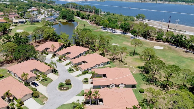 aerial view with a water view, a residential view, and golf course view
