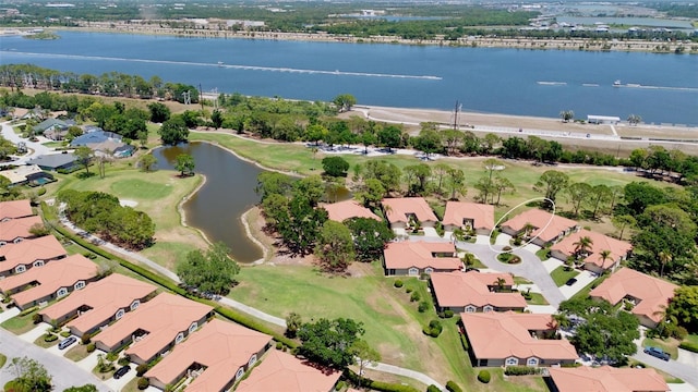 drone / aerial view featuring a residential view, a water view, and golf course view