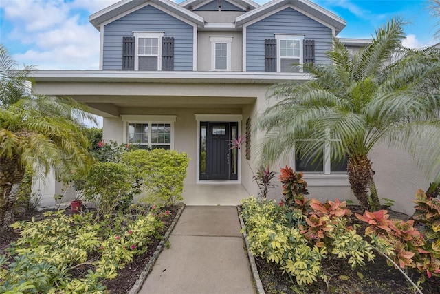 6001 Anise Dr, Sarasota, FL 34238 - entrance to property with a porch and stucco siding