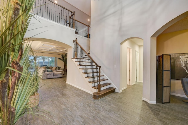 6001 Anise Dr, Sarasota, FL 34238 - entrance foyer featuring baseboards, stairs, wood finished floors, and arched walkways