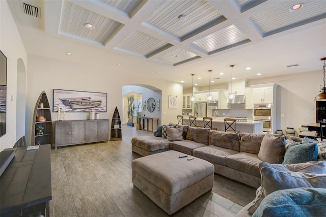 6001 Anise Dr, Sarasota, FL 34238 - living area with arched walkways, recessed lighting, beamed ceiling, visible vents, and coffered ceiling