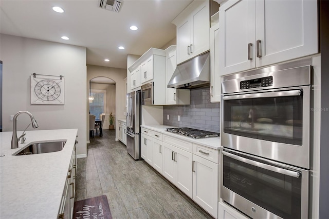6001 Anise Dr, Sarasota, FL 34238 - kitchen featuring appliances with stainless steel finishes, a sink, light countertops, under cabinet range hood, and visible vents