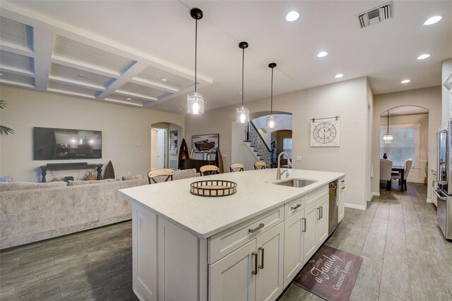 6001 Anise Dr, Sarasota, FL 34238 - kitchen with visible vents, arched walkways, a sink, and coffered ceiling