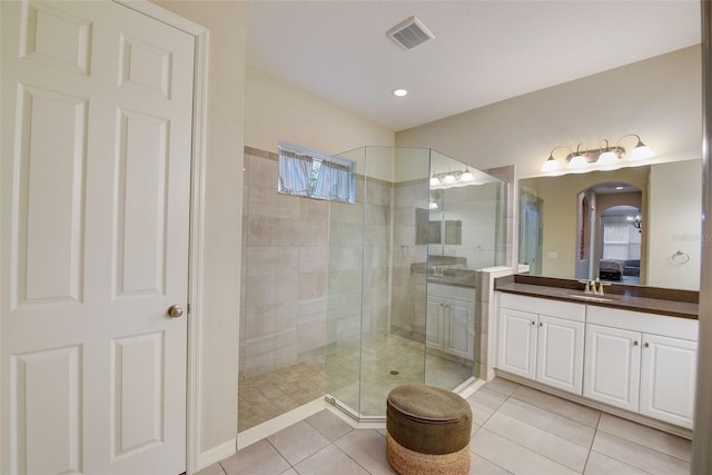 6001 Anise Dr, Sarasota, FL 34238 - bathroom with visible vents, vanity, connected bathroom, tile patterned floors, and a stall shower