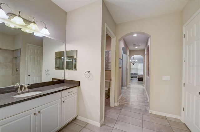 6001 Anise Dr, Sarasota, FL 34238 - bathroom with tile patterned flooring, ensuite bath, vanity, toilet, and baseboards