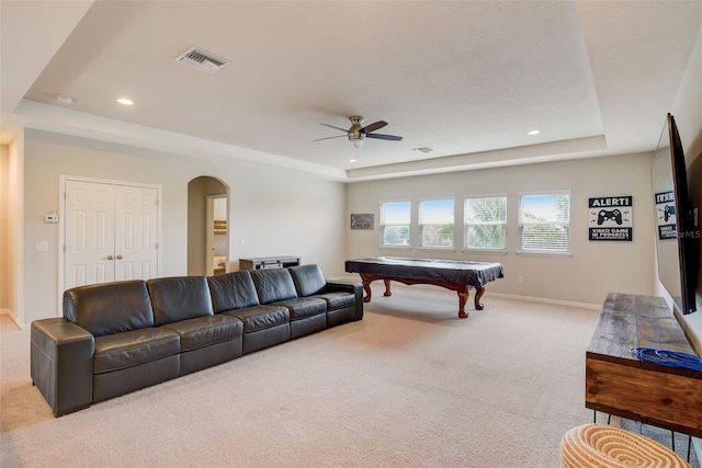 6001 Anise Dr, Sarasota, FL 34238 - carpeted living room featuring visible vents, baseboards, ceiling fan, a raised ceiling, and arched walkways