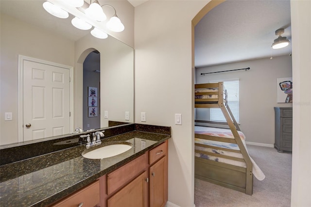 6001 Anise Dr, Sarasota, FL 34238 - bathroom with baseboards, a notable chandelier, and vanity