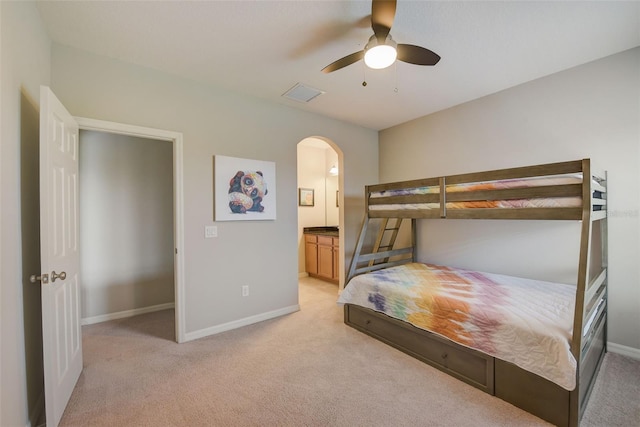 6001 Anise Dr, Sarasota, FL 34238 - bedroom with baseboards, arched walkways, and light carpet