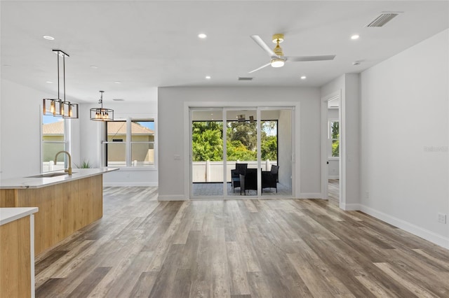 532 Yale Rd, Venice, FL 34293 - unfurnished living room featuring visible vents, a sink, baseboards, light wood-style floors, and recessed lighting