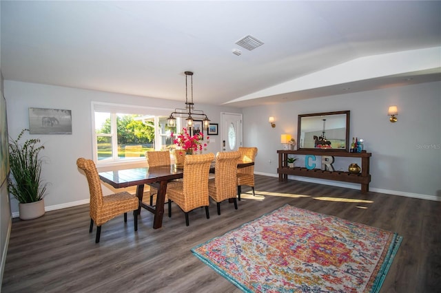 dining space with baseboards, vaulted ceiling, wood finished floors, and visible vents