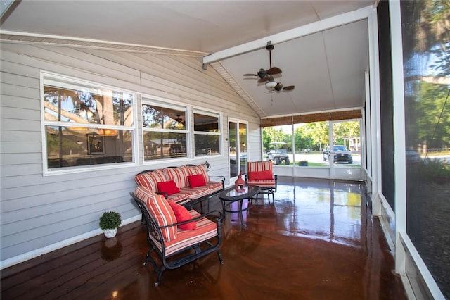 sunroom / solarium featuring a ceiling fan and beam ceiling